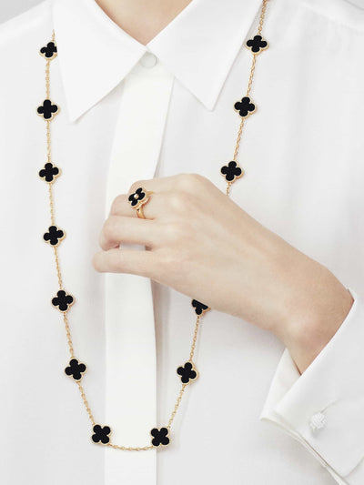 Model showcasing Fleuron Paris Necklace - Clover Leaf Gold Necklace in black onyx with matching ring, crafted in 925 silver and 18k gold plate.