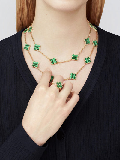 Model styled in Fleuron Paris Clover Leaf Gold Necklace in green malachite, 925 silver, 18k gold plated, paired with matching clover ring.