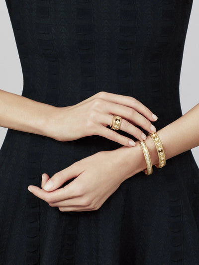 Model wearing Fleuron Paris Perlee Bangle - 18k gold plated with cubic zircon, styled with matching bracelets for a chic, sophisticated look.