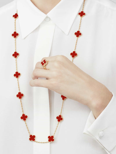 Model wearing Fleuron Paris Clover Leaf Gold Necklace in red carnelian, 925 silver, 18k gold plated, styled with matching ring for elegant look.