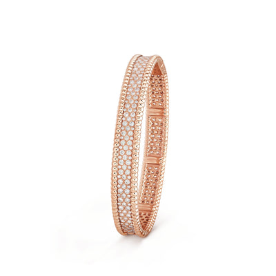 Angled view of Fleuron Paris Perlee Bangle in rose gold - 18k gold plated with cubic zircon, combining warmth and sparkle in design.